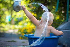 baby playing in pool